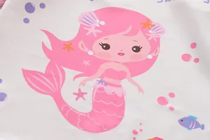 Close-up macro detail of an adorable pink mermaid character print on soft swimwear fabric