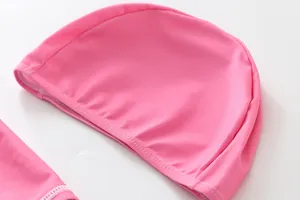 Detail shot of a bright pink elastic swim cap for girls mermaid swimsuit