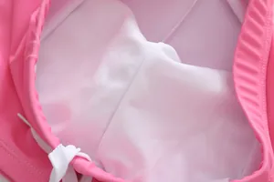 Close-up detail of breathable white mesh lining and drawstring on pink girls swimsuit