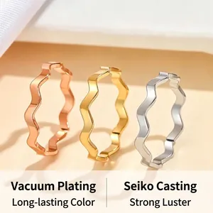 Close-up of stainless steel wavy band rings in gold, rose gold and silver finishes.