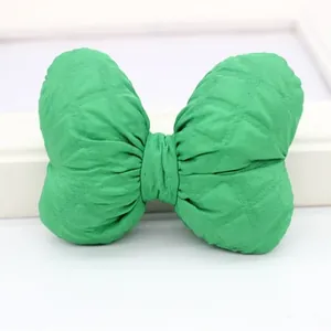 Green padded fabric bow with quilted texture for DIY hair accessories and craft decor