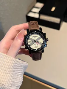 Close-up detail of fashion quartz watch featuring brown leather strap and peace sign dial