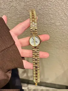 Close-up view of a vintage gold bracelet watch with intricate quartz dial design