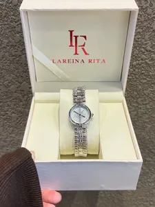 Detailed macro shot of a elegant silver quartz watch presented in a luxury Lareina Rita gift box