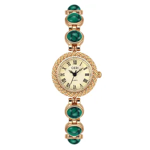 Montre-bracelet vintage dorée pour femme avec pierres turquoise vertes et chiffres romains