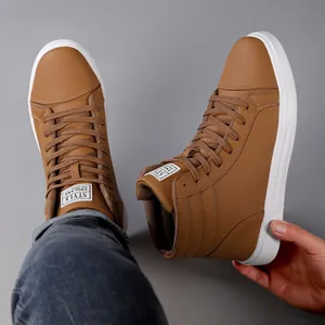 Detail shot of brown high-top casual leather boots with white soles and lace-up design.