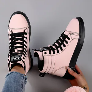 Close-up detail showing pink high-top leather fashion boots with black laces and sole