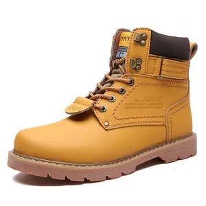 Macro detail view of a yellow leather work boot showing side stitching and texture