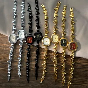 Detail view showing various colors of vintage quartz watches with geometric link straps