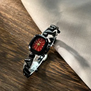 Vintage women's quartz watch with a red octagonal dial and black irregular bracelet strap.