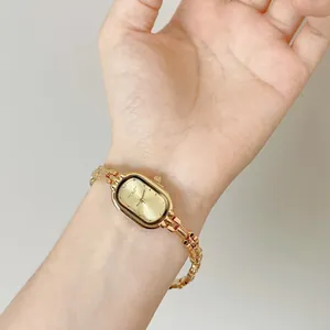 Elegant vintage-style gold steel band watch for women featuring a minimalist oval dial