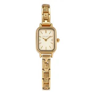 Vintage style women's gold watch featuring a rectangular dial and textured steel link band.