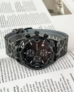 Detailed close-up of GUOU chronograph watch featuring leopard print silicone strap and dark dial.