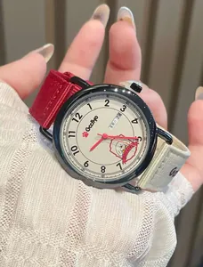 Close-up of GCCLIYO ladies quartz watch with cartoon dog dial and red canvas strap.