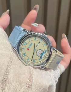 Detail of GCCLIYO women's quartz watch featuring a cute cartoon dog and canvas strap.