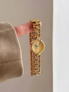 Luxury vintage gold bracelet watch for women with an elegant minimalist round dial design
