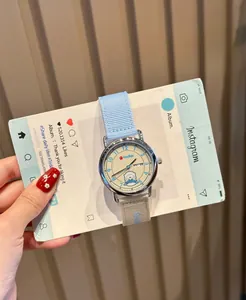 Close-up of GCCLIYO women's quartz watch with blue canvas strap and cute dog dial