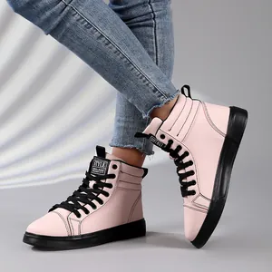 Close-up of pink high-top leather fashion boots with black laces and rubber soles