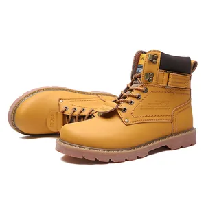 Macro view of yellow leather work boots with sturdy rubber outsoles and stitching