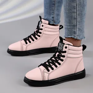 Detailed side view of pink high-top fashion boots with black soles and lace-up design