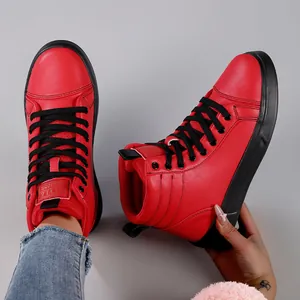 Detail view of vibrant red high-top boots with black laces and durable rubber sole