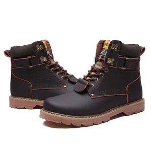Detailed shot of brown leather men's boots with rugged soles and metal eyelets.