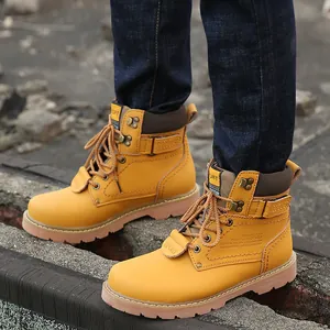 Macro detail view of yellow leather retro work boots with durable rugged rubber outsoles