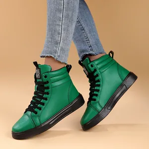 Detailed view of vibrant green high-top fashion boots with black laces and thick soles