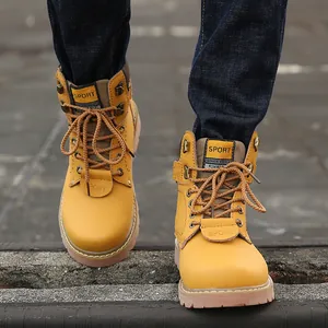 High-quality close-up of yellow leather vintage men's work boots with rugged lace-up details