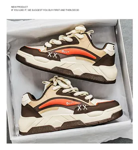 Gedetailleerd overzicht van dikke bruine en oranje sneakers met dikke veters in doos
