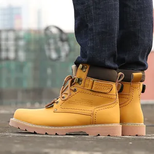 Close-up side view of classic yellow leather work boots with embossed details and thick soles