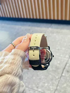 Detail of two-tone canvas strap and stainless steel buckle of Gccliyo women's watch