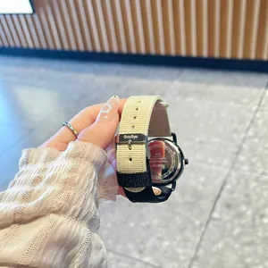 GCCLIYO luxury women's quartz watch featuring a stylish contrast beige and black canvas strap