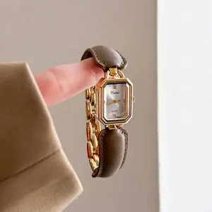 Elegant vintage gold bracelet watch for women with quartz movement and brown leather strap