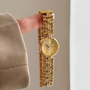 Elegant vintage gold-toned chain bracelet watch featuring a minimalist round dial design