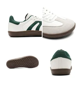 Close-up details of white and green retro sneakers showing suede toe and rubber sole.