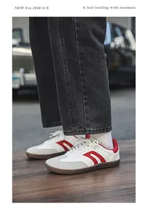 Detail view of retro wide-toe sneakers in white and red leather with brown gum sole.