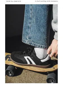 Detailed shot of wide-toe barefoot sneakers being worn while standing on a skateboard