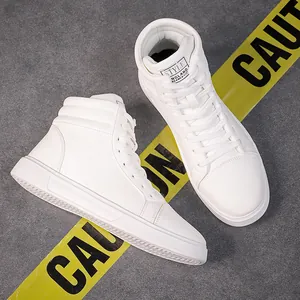 Close-up of stylish white high-top leather boots on a textured grey background