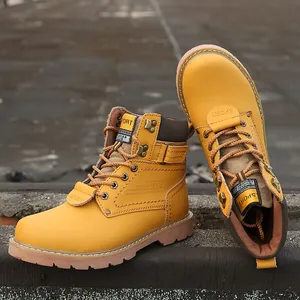 Detailed view of yellow leather work boots with 'SPORT' engraving and rugged sole