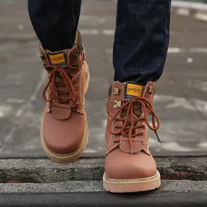 Close-up front view of classic brown leather work boots on a person standing outdoors