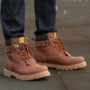 Close-up of brown leather work boots with white stitching and durable rubber sole