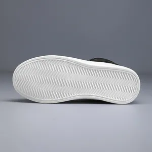 Detailed view of white anti-slip rubber sole with herringbone pattern for leather boots