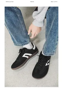 Detail view of black wide-toe barefoot sneakers with white accents and gum sole.