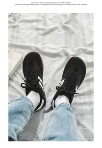 Detailed view of black wide toe box barefoot sneakers on casual fabric background