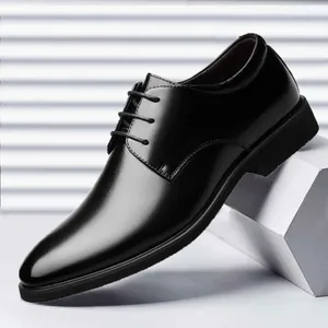 Close-up of black men's formal leather dress shoes with lace-up detail and polished finish.