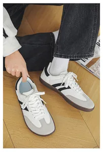 Stylish close-up of white wide toe barefoot sneakers on a natural wooden floor