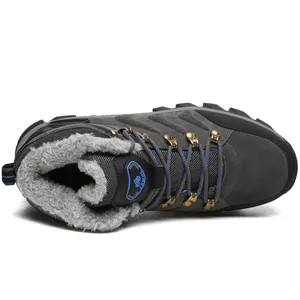 Detailed view of high-top winter hiking boot with thick grey faux fur lining for warmth.