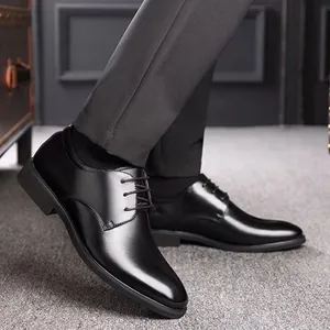Detailed close-up showing the sleek black leather finish of men's formal lace-up dress shoes