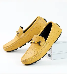 Detailed view of yellow men's casual loafers featuring ostrich skin texture and metal buckle